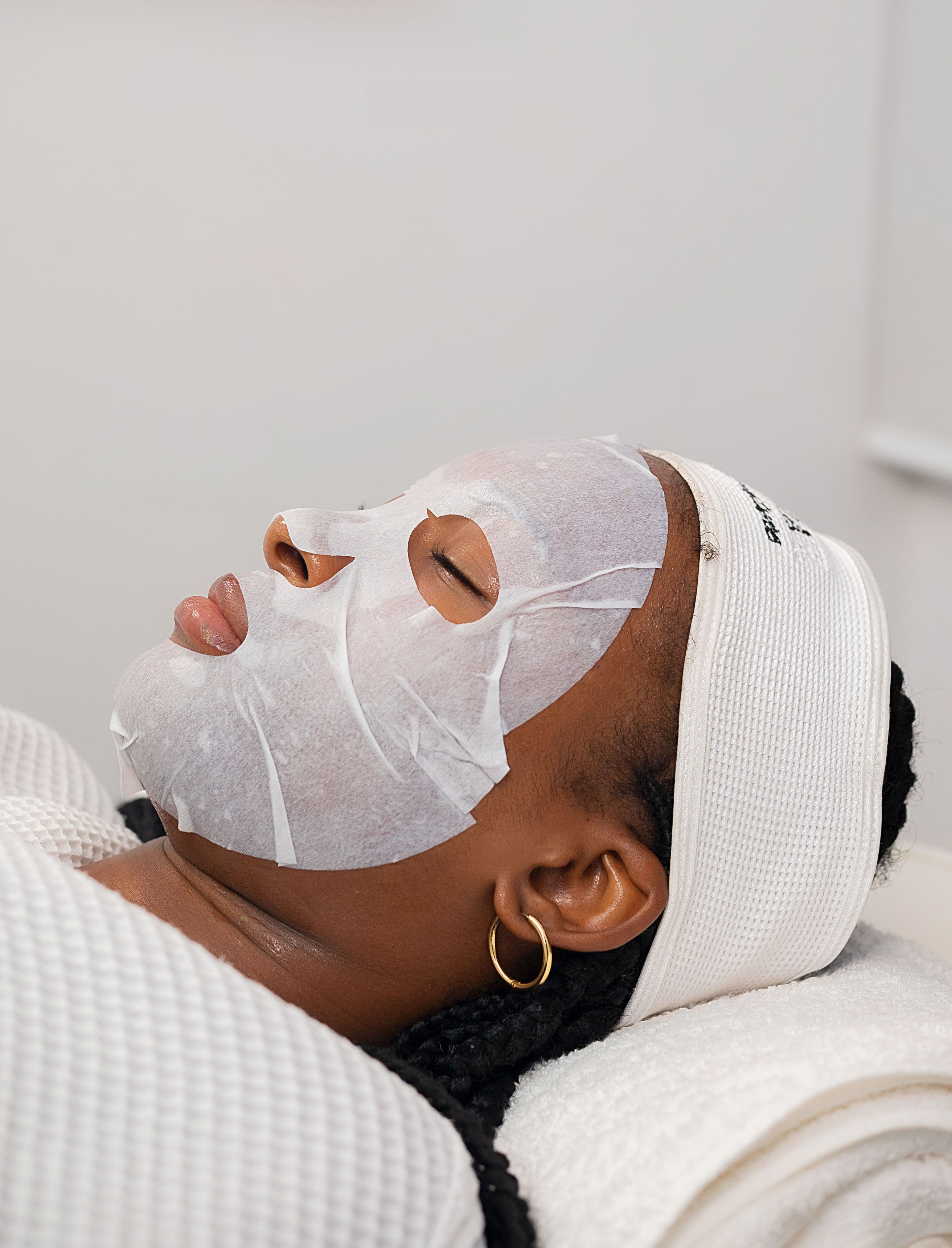Client relaxing during a mud mask facial at Mesopotamia Spa