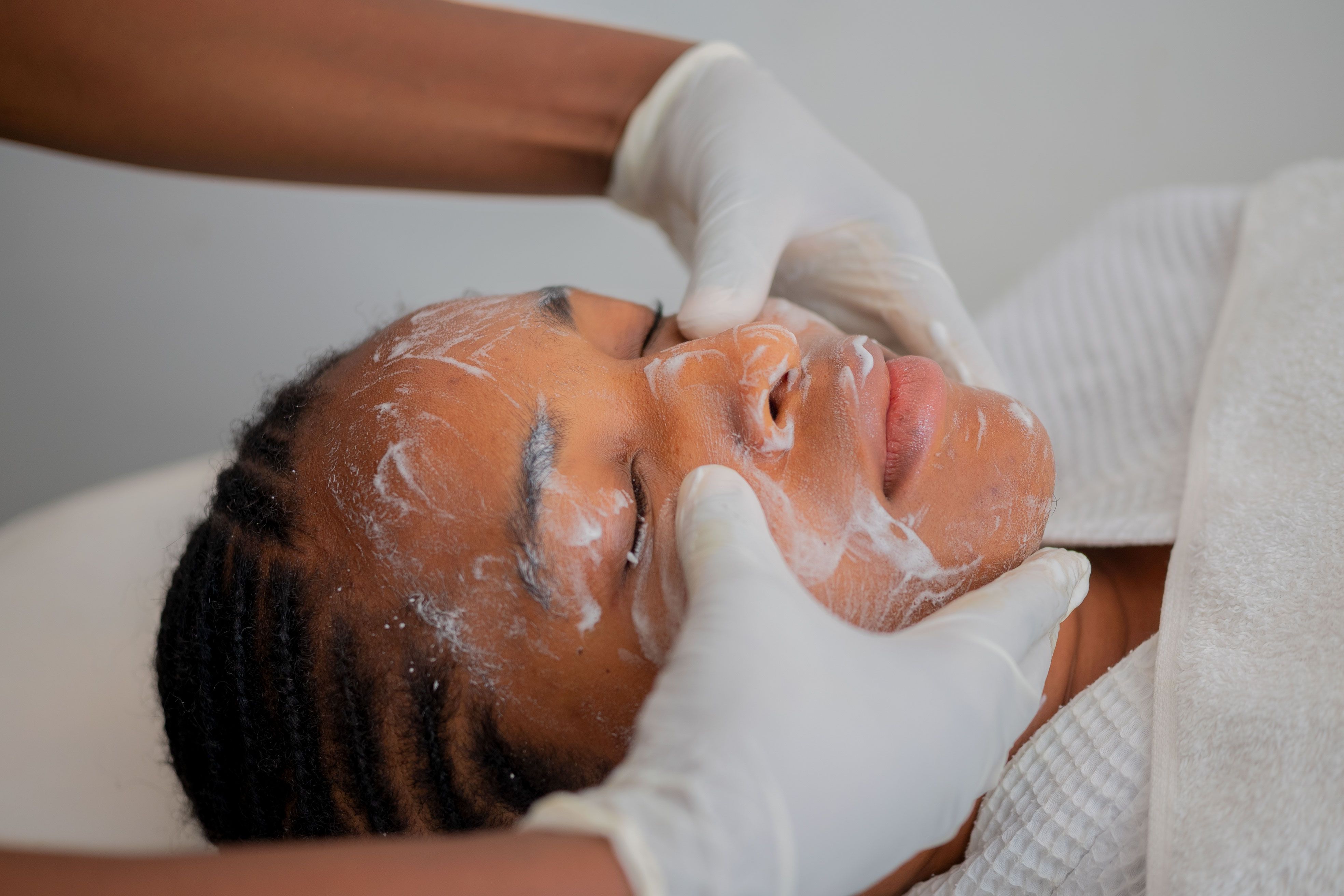 Client fully relaxed during a facial treatment at Mesopotamia Spa